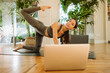 © Gerard Moral Casanovas/Westend61 - Female yoga instructor exercising during online class through laptop