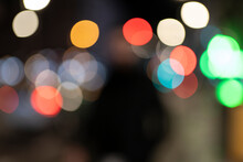 Defocused Image Of Multi Colored Illuminated Lights In City At Night