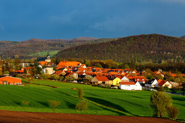 Wall Mural - clouds and rain over the village of herleshausen in hesse