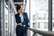 © Joseffson/Westend61 - Happy businesswoman talking on mobile phone on office balcony