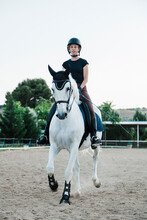 Woman Wearing Headwear Riding White Horse Against Clear Sky In Farm