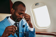 © OneInchPunch/Westend61 - Young businessman emotionally stressed traveling in private jet