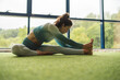 © Mikel Taboada/Westend61 - Young female athlete doing stretching exercise at health club
