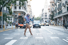 Drag Queen Gesturing Peace Sign While Crossing Street In City