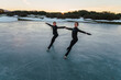 © CSSHOT/Westend61 - Two female figure skaters practicing together on frozen lake at dusk