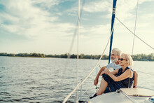 Romantic Vacation And Luxury Travel. Senior Loving Couple Sitting On The Yacht Deck. Sailing The River.