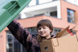 © Sigrid Gombert/Westend61 - Young woman putting cardboard box in garbage bin