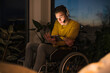 © Uwe Umst√§tter/Westend61 - Disabled young man using digital tablet while sitting on wheelchair in living room
