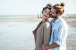 © Uwe Umst√§tter/Westend61 - Affectionate young couple at beach on sunny day during weekend