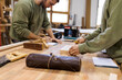 © Valentina Barreto/Westend61 - Craftsmen working at table in workshop