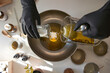 © Veam/Westend61 - Woman mixing ingredients in steel bowl while making soap in workshop