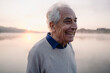 © Gustafsson/Westend61 - Happy man looking away while standing against lake