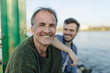 © Gustafsson/Westend61 - Happy father by son against river