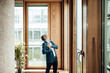 © Gustafsson/Westend61 - Senior businessman laughing while standing in office corridor