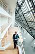 © Gustafsson/Westend61 - Senior businessman using digital tablet while walking on staircase