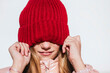 © Jose Luis CARRASCOSA/Westend61 - Playful girl covering eyes through knit hat against wall
