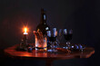 © Thomas J√§ger/Westend61 - Studio shot of bottle of red wine, three filled wineglasses, plums, salty pretzels and burning candle on small coffee table