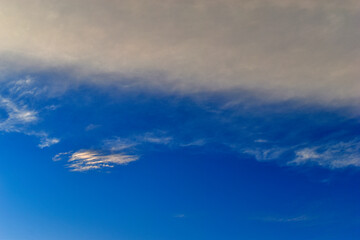 Evening blue sky with a gray cloud