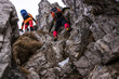 © 27exp/Westend61 - Men with backpack climbing on rocks