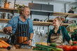 © Mareen Fischinger/Westend61 - Male chef talking with colleague while cooking in kitchen