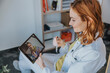 © Mareen Fischinger/Westend61 - General practitioner talking with patient through video call over digital tablet at office