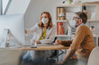 © Mareen Fischinger/Westend61 - General practitioner wearing protective face mask explaining male patient over computer at doctor's office