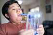 © No-Te - Fat boy uses a Tri-ball Incentive Spirometer for check his lung function.