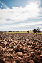 Freshly plowed agricultural field against sky