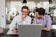 © Daniel Ingold/Westend61 - Business people discussing over laptop during meeting at office