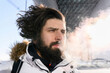 © Ekaterina Yakunina/Westend61 - Male hipster exhaling smoke during winter