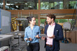 © Florian K√ºttler/Westend61 - Businessman and businesswoman discussing strategy in factory