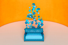 Blue Sofa And Spheres Against Orange Wall