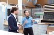 © Florian K√ºttler/Westend61 - Male and female entrepreneur discussing while standing in factory