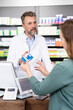 © Florian K√ºttler/Westend61 - Mature pharmacist advising customer about medicine at checkout in store
