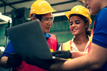 Scene of industrial inspectors team discussing using laptop checking the safety and review function in a metal factory, concept auditor safety, quality control in a factory, quality inspection.