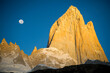 © Tandem Stock - Fitz Roy with the first rays of sunshine and the full moon setting, Patagonia, Argentina.