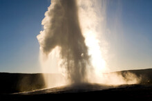 A View Of Old Faithful Geyser In Yellowstone National Park, Wyoming.