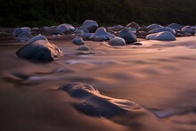 Sunset Casts A Golden Glow Over The Cangrejal River, Honduras.
