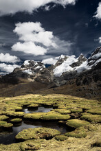 Mountain Peaks And What Looks Like Giant Moss Covered Toad Stools In A Surreal Looking Landscape Located In The Cordillera Huayhuash In The Andes Mountains Of Peru.