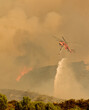 © Tandem Stock - Helicopter dropping water on fire