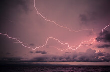 Bolts Of Lightning During A Tropical Electric Storm Over The Caribbean Sea Just Before Sundown.