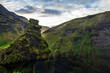 © Tandem Stock - A rock formation which looks like a troll's head overlooks Skogafoss, a waterfall in Southern Iceland, near the town of Hvolsvollur.