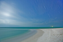 Nighttime On White Sand Beach With Crystal Clear Water With Stars Over The Gulf Of Mexico On Anna Maria Island, Florida