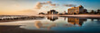 © Tandem Stock - Jacksonville, Florida: The sun rising and lighting up the buildings as they reflect off the water left from low tide