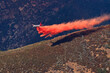 © Tandem Stock - Fixed-wing aircraft dropping retardant along ridge in advance of approaching Rim Fire, Sierra Nevada, California