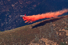 Fixed-wing Aircraft Dropping Retardant Along Ridge In Advance Of Approaching Rim Fire, Sierra Nevada, California