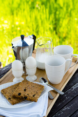 Wall Mural - Breakfast for two on an old table in the summer garden