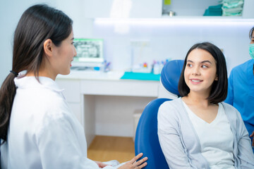 Wall Mural - Caucasian girl patient consulting dentist about oral care or treatment