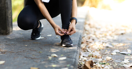 close up of woman tying shoe laces