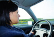 Closeup shot of a Caucasian young woman is driving a car in the Netherlands